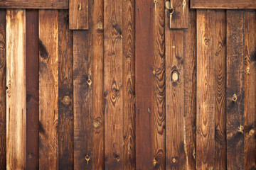 Obraz premium The texture of a wooden old vintage fence made of planks. Natural color of faded wood. Old nails