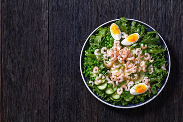 pink cocktail shrimps salad with veggies on plate