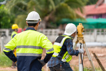 Surveyor Civil Engineer with equipment on the construction site.