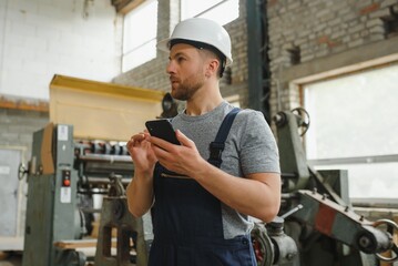 worker in factory on the machine