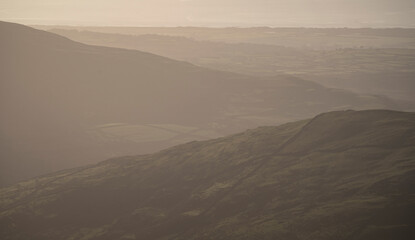 Fototapeta na wymiar Murky mountain scene with coastal background in Snowdonia national park
