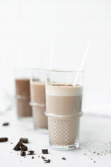 three glasses with chocolate milkshakes