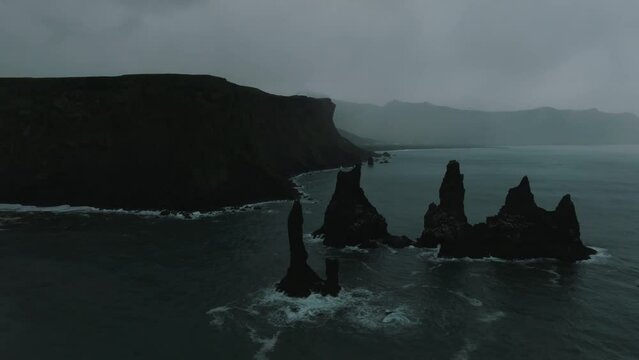 Iceland black sand beach with huge waves at Reynisfjara Vik. Aerial cinematic 4k video. Beautiful Iceland nature coastline from above.