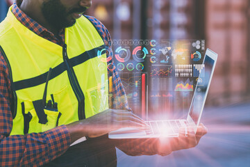 engineer staff worker using  laptop monitor business information data screen at port cargo shipping.