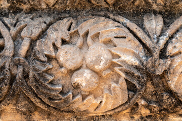 Close up of pomegranates carving at the ruins of Capernaum in Israel other names Kfar Nahum or Capharnaum.
