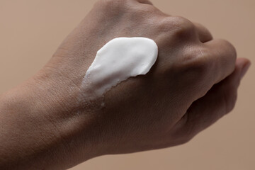 Applying sunscreen on woman hand, Sun lotion smear stroke on skin