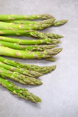 Green asparagus on a gray bockground. Seasonal fresh food
