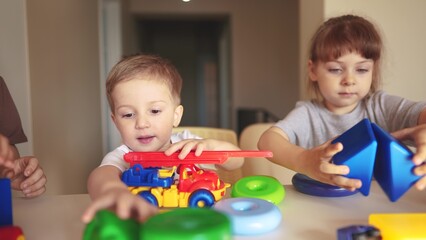 kindergarten. a group of children play toys cubes and cars on the table in kindergarten. kid dream creative lifestyle happy family preschool education concept. nursery baby toddler home