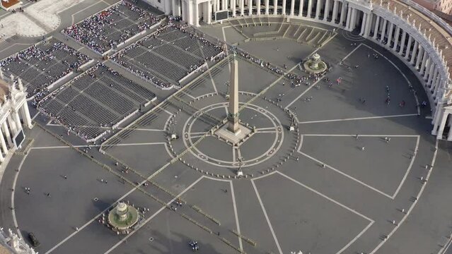 Aerial view of the colonnade and St. Peter's square located in the Vatican city. This state is an enclave within the city of Rome, Italy. The obelisk in the center is known as "The Witness".