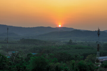 Natural blurred background of fog scattered among trees in the morning, with soft sunlight from the sun, seasonal beauty.