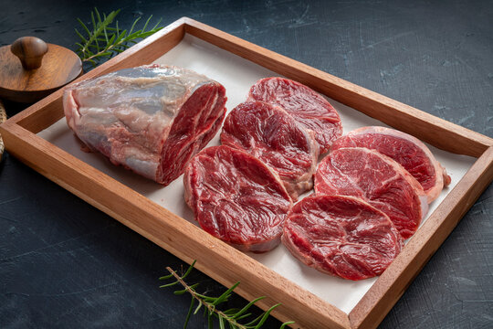 Fresh Silver shank meat in wooden plate on wooden background, Shank beef first grade in wooden plate on wooden background.	