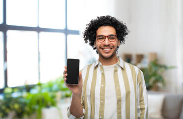 technology and people concept - smiling man in glasses showing smartphone with blank screen over...