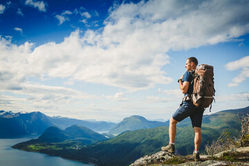 Fototapeta na wymiar Traveller with backpack and mountain panorama