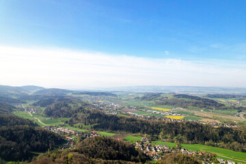 Fototapeta na wymiar Aerial view over rural landscape seen from local mountain Uetliberg on a blue cloudy spring day. Photo taken April 21st, 2022, Zurich, Switzerland.