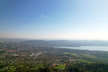 Aerial view over City of Zürich with bay of Lake Zürich on a beautiful spring day with blue cloudy sky background. Photo taken April 21st, 2022, Zurich, Switzerland.