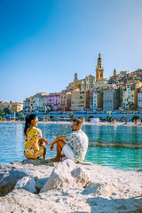 Menton France,couple men and woman on vacation at the Cote d Azur France, View on old part of...
