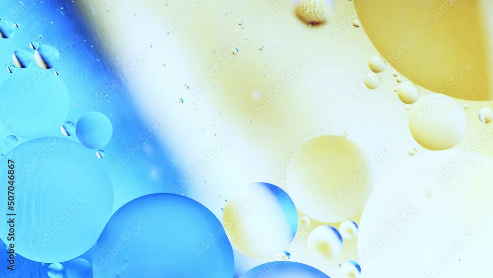Aufkleber real close up oil bubbles in water rotation with color gradient abstract mixing background.