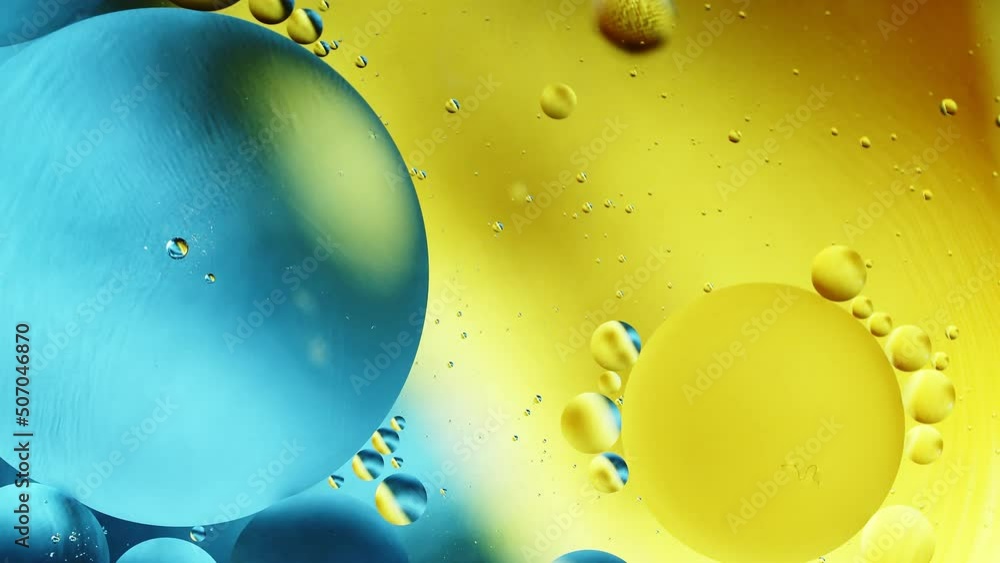 Poster real abstract colourful oil drops in water rotation with color gradient mixing background.