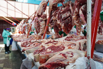 Almaty, Kazakhstan - 03.25.2022 : Different parts of meat are prepared for sale on the open market.