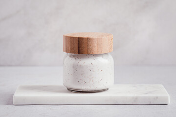 Cosmetic product in eco friendly packaging on marble tray on light gray background