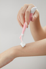 Front view of holding cosmetic roller on hand in white background for cosmetic advertising	
