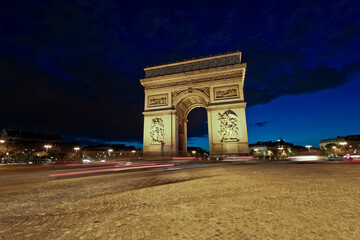Paris Arc de Triomphe and street at night, France
