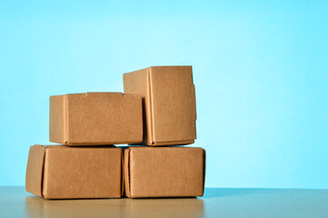 Stack of cardboard boxes isolated on a blue background. Stock market and commodity concept.
