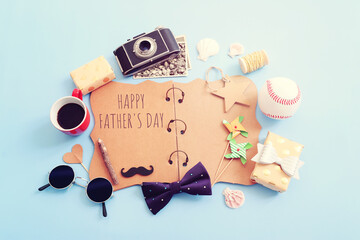 Father's day concept. bow tie, glasses, old photo camera and funny moustache over blue background. top view, flat lay