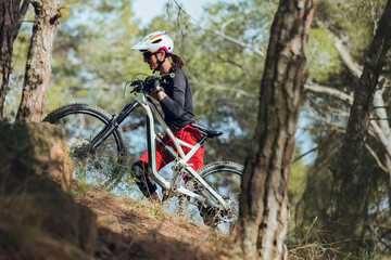 Young girl practicing enduro mtb on trail in the mountains