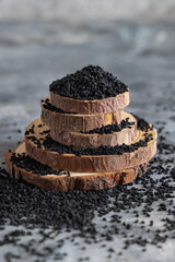 Indian spice Black cumin (nigella sativa or kalonji) seeds close up with a wooden spoon