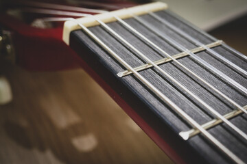 Classical guitar close up. Acoustic guitar background, strings, frets, pegs.