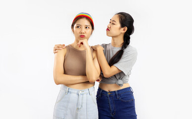 Photo of Young asian women in concept of lgbt couple isolated on white wall background.