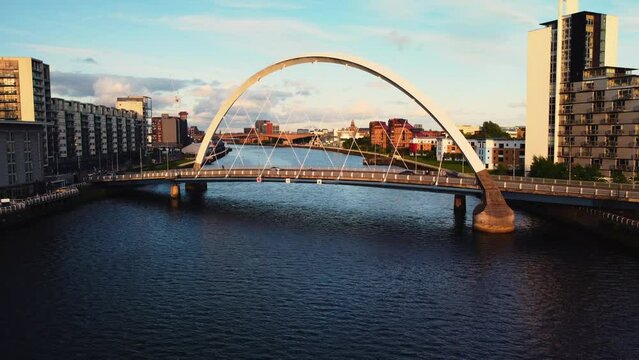 Aerial drone shot of Glasgow at sunset bridge over river clyde