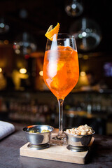 Aperol cocktail with orange in a glass on a dark background