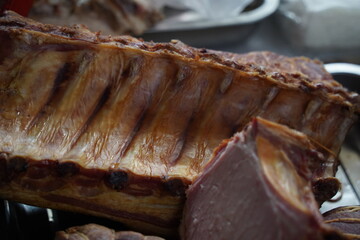 Almaty, Kazakhstan - 03.25.2022 : Smoked meat products are laid out for sale in an open market