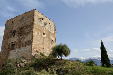 Fototapeta na wymiar View of the Ulloa tower in the Granada town of Vélez de Benaudalla (Spain) on a sunny spring morning