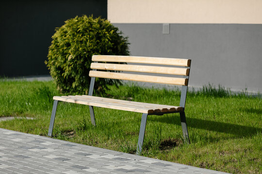 wooden bench on the street near the house