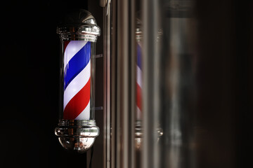 Barber shop vintage pole. copyspace Barbershop. Barber shop pole in red white and blue with lightbulb on top.