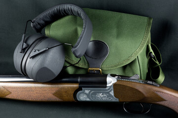 Shotgun with Cartridge Bag and Hearing Protectors