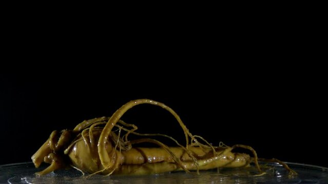 Ginseng root pouring into water slow motion
