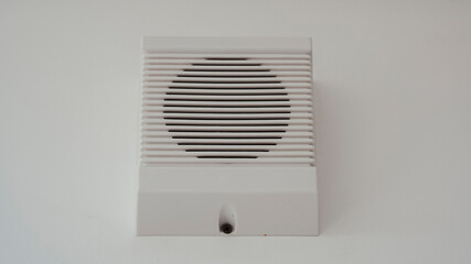 White loudspeaker of the fire system on white wall. Fire safety speaker