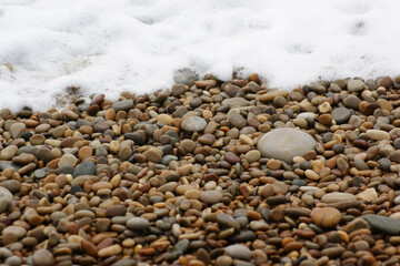 It is a stone that has been cut into a round pebble shape as the rock has been broken and eroded by waves and wind over a long period of time. To the touch, it is as smooth as silk.