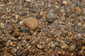 It is a stone that has been cut into a round pebble shape as the rock has been broken and eroded by waves and wind over a long period of time. To the touch, it is as smooth as silk.