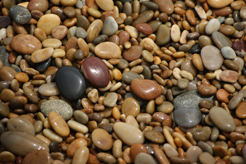 Fototapeta na wymiar It is a stone that has been cut into a round pebble shape as the rock has been broken and eroded by waves and wind over a long period of time. To the touch, it is as smooth as silk.