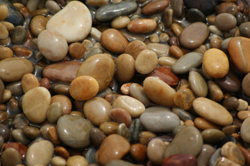 It is a stone that has been cut into a round pebble shape as the rock has been broken and eroded by waves and wind over a long period of time. To the touch, it is as smooth as silk.