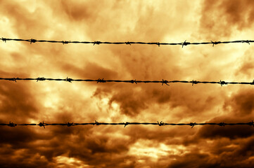 dramatic sky and barbed wire