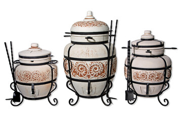 tandoor oven for barbecue and roasting meat made of clay and various drawings with skewers and with a pan with a grill and a cauldron