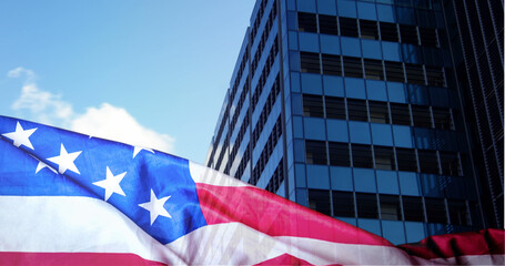 Fototapeta na wymiar American flag against city 