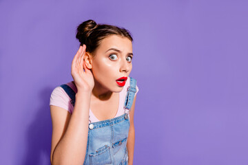 Photo of young pretty girl arm near ear look interested listen conversation isolated on violet...