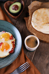 Breakfast with fried eggs with tomato, bacon and avocado